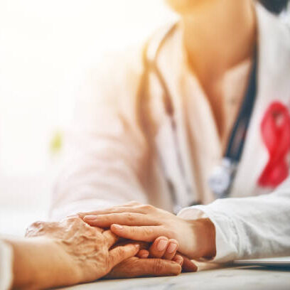 Pink ribbon for breast cancer awareness. Female patient listening to doctor in medical office. Support people living with tumor illness.